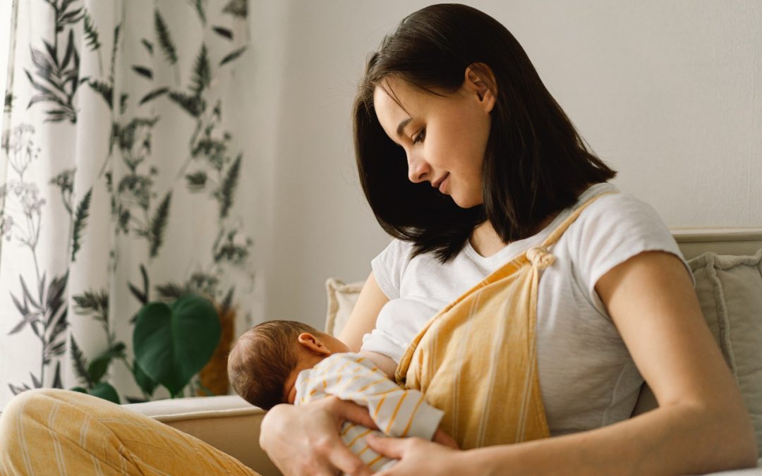 woman holding a baby breastfeeding