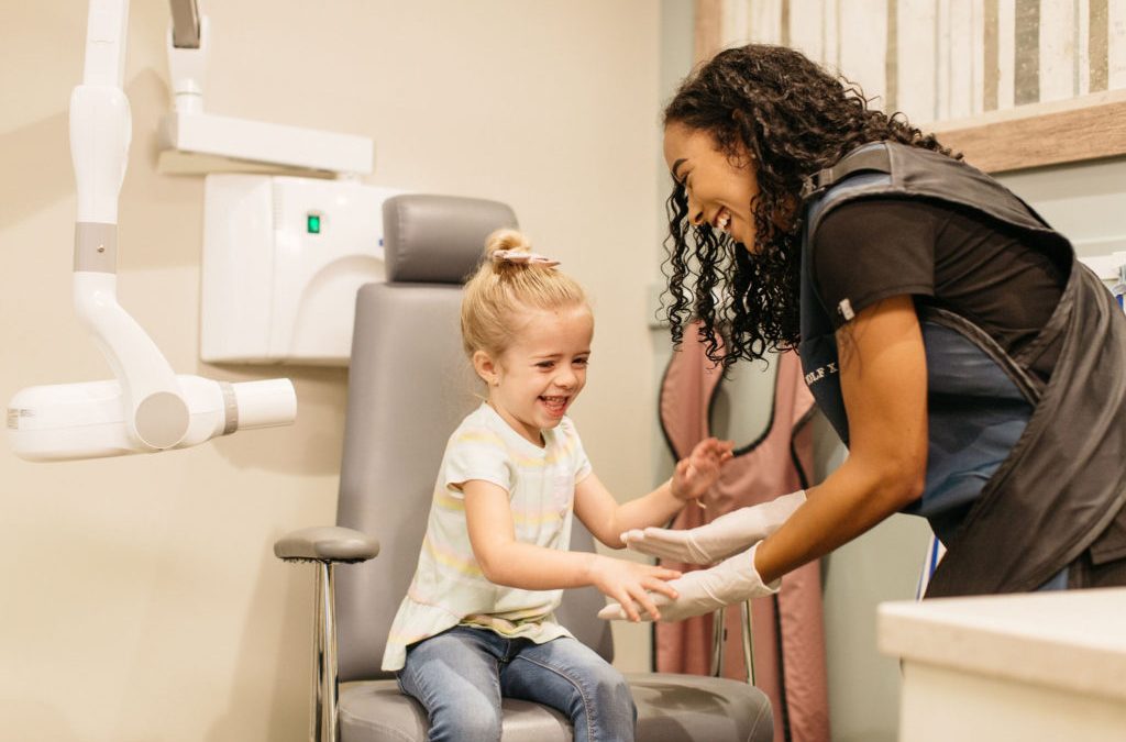child getting out of xray chair at pediatric dentist office