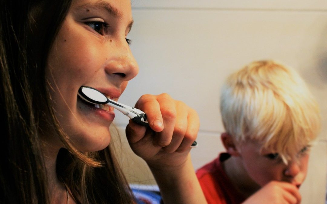 two children brushing and flossing properly